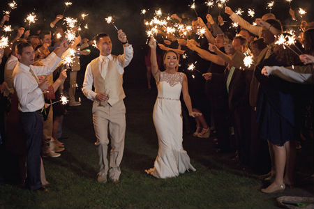 newlyweds exiting wedding with sparklers